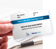 Hand holding a Novo Nordisk® Savings Card